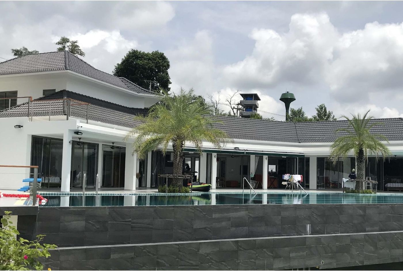 By the Hill Villa, dark modern facade with pool terrace