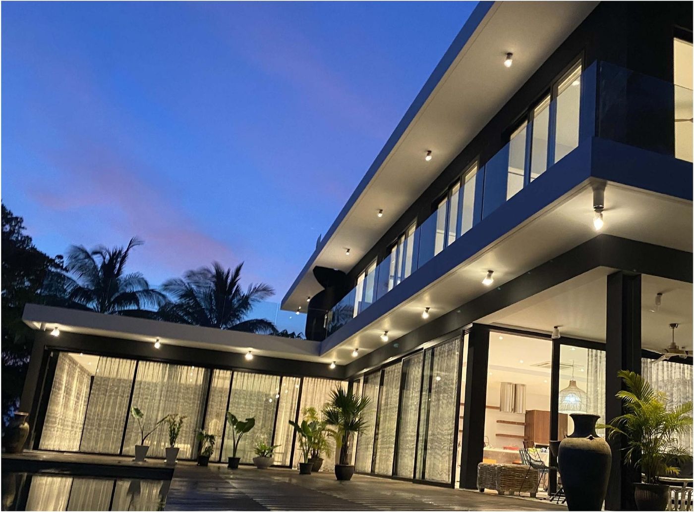 Jackie's House, twilight view of modern glazed villa
